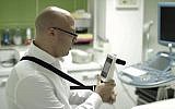 A doctor uses a  MobileODT colposcope (Photo credit: Courtesy)