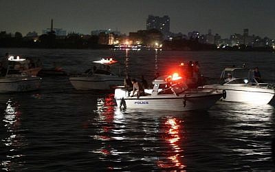 Rescuers search for victims in Cairo, Egypt on July 23, 2015 where at least 21 people including two children were killed after a cargo boat collided with a ferry on the Nile. (AFP PHOTO/ STR)