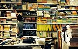 Illustrative image of a boy searching for books in Jerusalem's Intercol school supply store (Jessica Steinberg/Times of Israel)