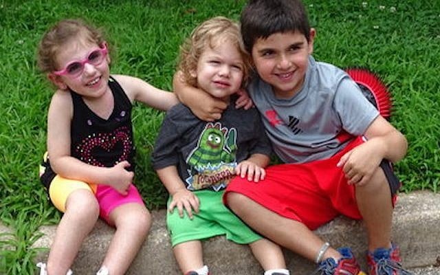 From left to right: Jamison, Grayson and Jackson Eberstein, taking a break from playing (Suzanne Pollak/Washington Jewish Week/JTA)