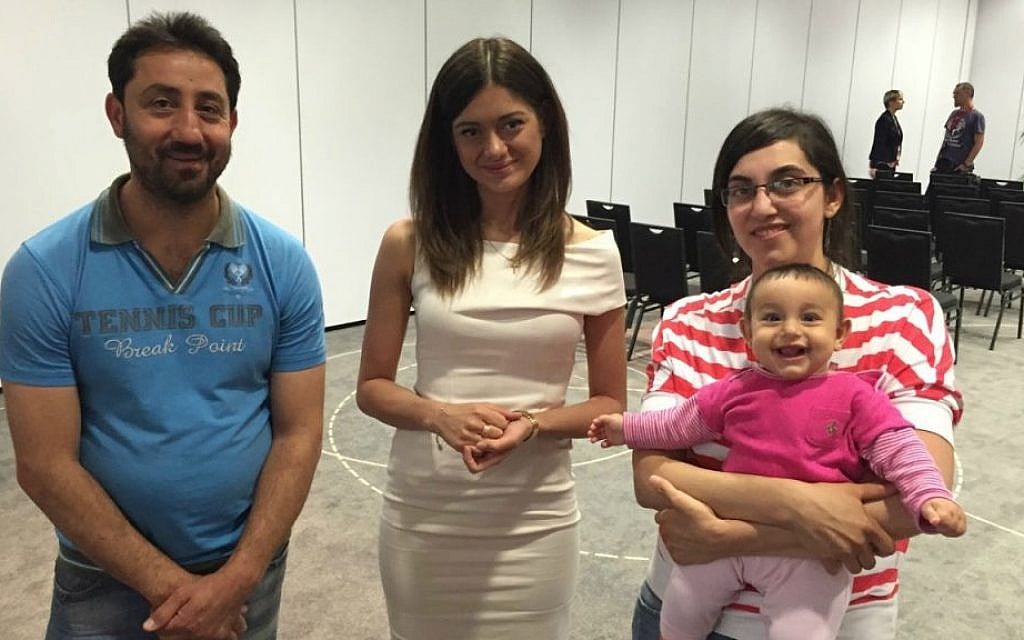 A young Christian Syrian couple with their seven month old daughter flank Miriam Shaded, a Polish church charity worker, who will help the families resettle in Poland, in Warsaw last week. Shaded has a Syrian Christian background and works for the Esther Foundation. (courtesy) A young Christian Syrian couple with their seven month old daughter flank Miriam Shaded, a Polish church charity worker, who will help the families resettle in Poland, in Warsaw last week. Shaded has a Syrian Christian background and works for the Esther Foundation. (courtesy)