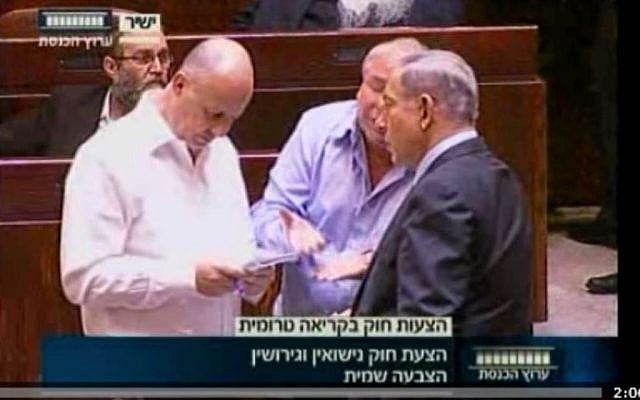 The prime minister participates in the vote on Zahava Gal-on’s private member’s bill on marriage and divorce. He is counting heads together with coalition whip Tzachi Hanegbi and MK David Amsalem in the Knesset plenum on July 8, 2015 (Knesset Channel screenshot)