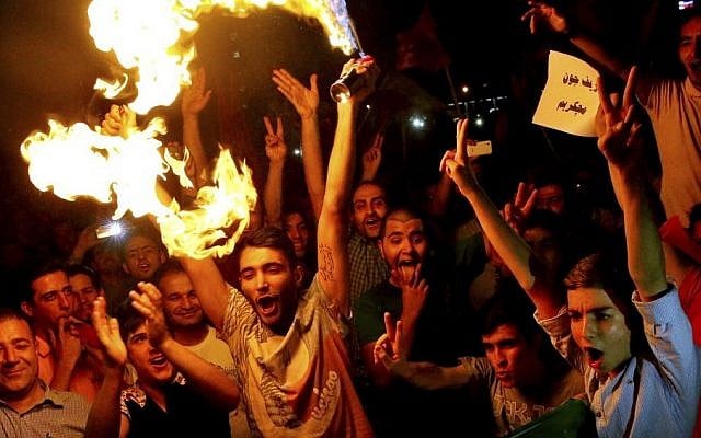 Iranians celebrate following a landmark nuclear deal in Tehran, Iran, Tuesday, July 14, 2015.  (AP Photo/Ebrahim Noroozi)