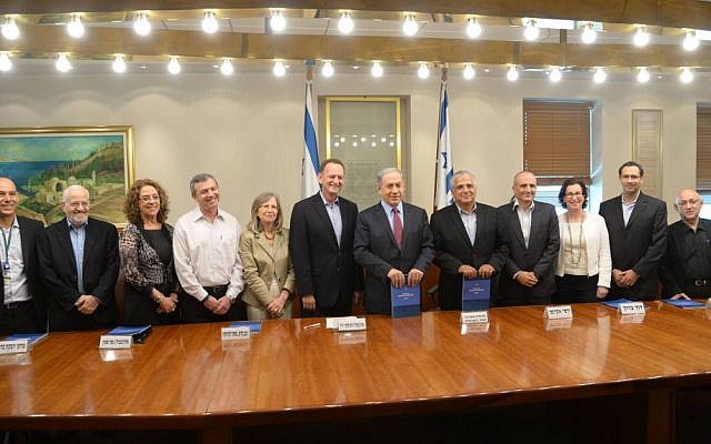 Committee chief Maj. Gen. (res) Yohanan Locker, center, stands alongside Prime Minister Benjamin Netanyahu after presenting his commission's recommendations for the defense budget. (Amos Ben Gershon/ GPO) Committee chief Maj. Gen. (res) Yohanan Locker, center, stands alongside Prime Minister Benjamin Netanyahu after presenting his commission's recommendations for the defense budget. (Amos Ben Gershon/ GPO)
