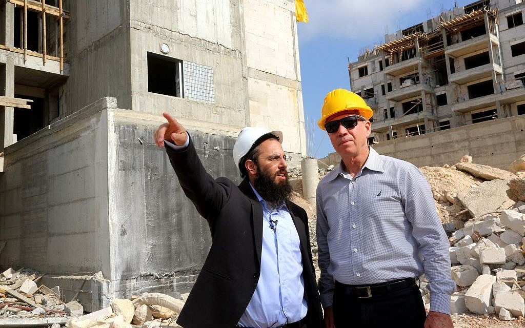 Yoav Gallant (right) inspects construction currently underway in the town of Harish, July 2, 2015. (Courtesy)