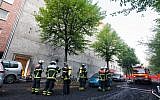 Firefighters stand outside a WWII bunker that caught fire amid an explosion that wounded 21 people in Hamburg, Germany, August 4, 2015.  (AFP/DPA/DANIEL BOCKWOLDT)