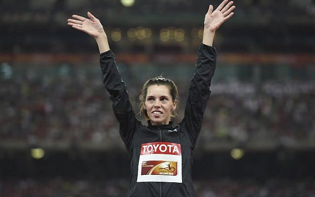 Israel's Hanna Knyazyeva-Minenko celebrates her silver medal on the podium during the victory ceremony for the women's triple jump athletics event at the 2015 IAAF World Championships at the 'Bird's Nest' national stadium in Beijing on August 24, 2015 (AFP PHOTO / GREG BAKER) Israel's Hanna Knyazyeva-Minenko celebrates her silver medal on the podium during the victory ceremony for the women's triple jump athletics event at the 2015 IAAF World Championships at the 'Bird's Nest' national stadium in Beijing on August 24, 2015 (AFP PHOTO / GREG BAKER)