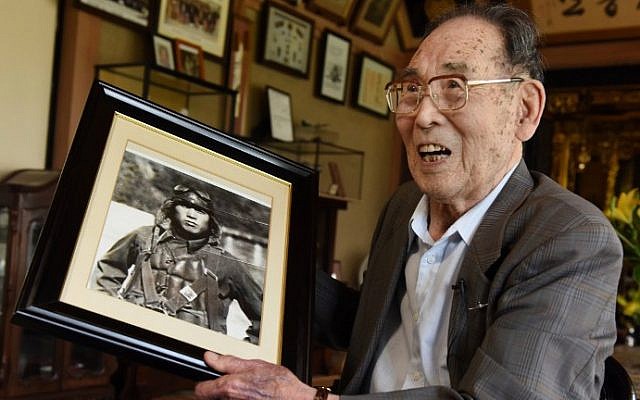 In this photo taken on June 25, 2015, former Japanese fighter pilot Kaname Harada, 98, holds his portrait as a young man as he tells his experience during World War II at his home in Nagano, Japan. (AFP Photo/Toru Yamanaka) In this photo taken on June 25, 2015, former Japanese fighter pilot Kaname Harada, 98, holds his portrait as a young man as he tells his experience during World War II at his home in Nagano, Japan. (AFP Photo/Toru Yamanaka)