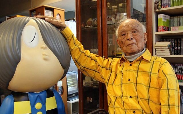 This picture taken on May 12, 2015 shows Japanese 93-year-old comic artist Shigeru Mizuki showing his famous character "Kitaro" as he speaks at his studio in Tokyo. (AFP Photo/Yoshikazu Tsuno)