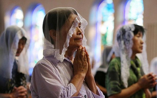 People attend a morning mass for victims of the World War II atomic bombing of Nagasaki at the city's Urakami Cathedral on August 9, 2015. (AFP Photo/Jiji Press)