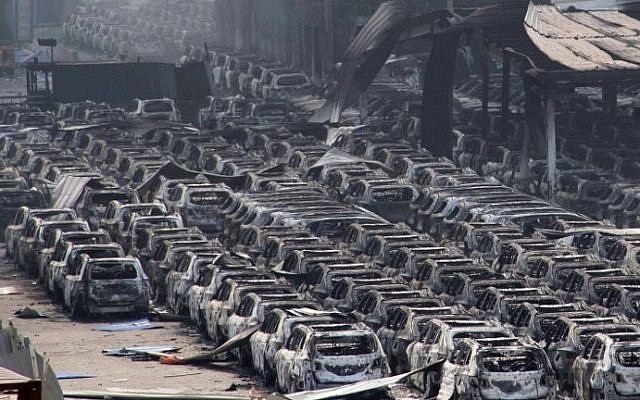 Damaged cars are seen at the site of a series of explosions in Tianjin, China on August 13, 2015.  (AFP)