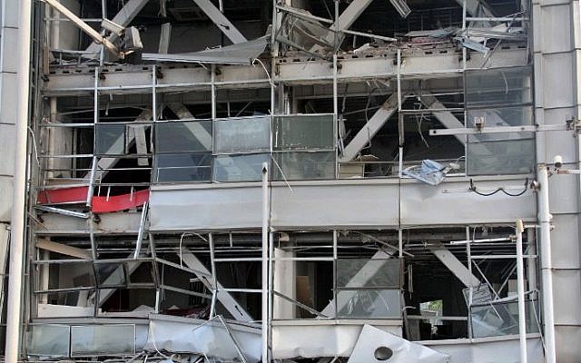 Shattered building windows are seen near the site of a series of explosions in Tianjin on August 13, 2015.  (AFP)
