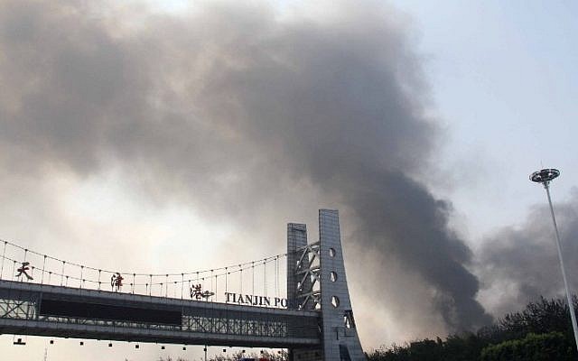 The Tianjin port gate is seen in the foreground as smoke rises from the site of a series of explosions in Tianjin on August 13, 2015. (AFP) The Tianjin port gate is seen in the foreground as smoke rises from the site of a series of explosions in Tianjin on August 13, 2015. (AFP)