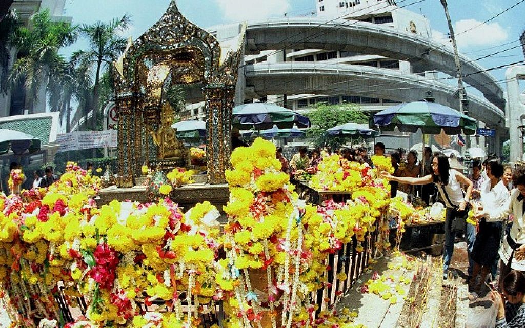 This file photo taken on September 9, 1999 shows tourists paying homage to the Erawan Shrine in central Bangkok. (AFP Photo/file/Pornchai Kittiwongsakul)