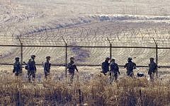 South Korean soldiers check a military iron fence in the border city of Paju near the demilitarized zone (DMZ) dividing the two Koreas, on March 27, 2013. (AFP/Files/Jung Yeon-Je)