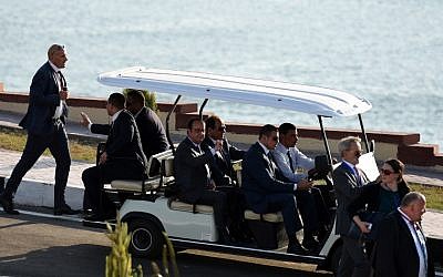 Egyptian President Abdel-Fattah el-Sissi and French President Francois Hollande ride on a cart during the opening ceremony of a new waterway at the Suez Canal on August 6, 2015, in the port city of Ismailiya. (AFP PHOTO/ MOHAMED EL-SHAHED)