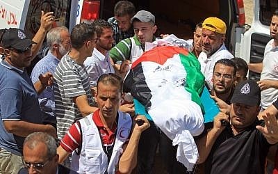 Members of the Palestinian Red Crescent Society carry the body of Saad Dawabsha, the father of a Palestinian toddler killed last week when their home was firebombed by Jewish extremists, during his funeral in the West Bank village of Duma on August 8, 2015. (AFP/ JAAFAR ASHTIYEH)