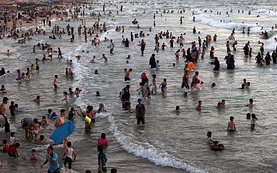 Palestinians swim in the Mediterranean Sea at a beach in Gaza City, August 14, 2015. (AFP/MOHAMMED ABED)