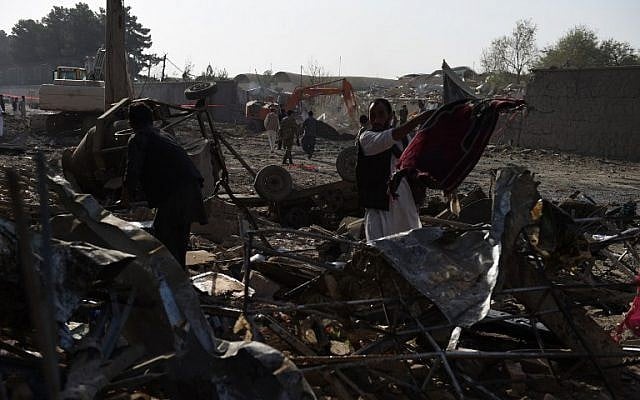 Afghan shopkeepers remove prayer rugs after a powerful truck bomb in Kabul, Afghanistan, on August 7, 2015. (AFP/Wakil Kohsar) Afghan shopkeepers remove prayer rugs after a powerful truck bomb in Kabul, Afghanistan, on August 7, 2015. (AFP/Wakil Kohsar)