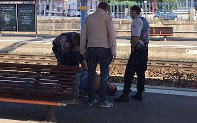 Police detaining a suspect on the platform at the main train station in Arras, northern France, on August 21, 2015, after an armed gunman on the train was overpowered by passengers. (AFP Photo/Courtesy of Christina Catherine Coons)