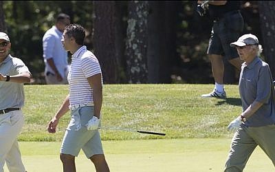US President Barack Obama walks alongside Cyrus Walker (C) and comedian Larry David (R) as they play golf at Farm Neck Golf Club in Oak Bluffs on Martha's Vineyard in Massachusetts, August 8, 2015. The Obama family is on a 2-week vacation. (AFP/ SAUL LOEB)