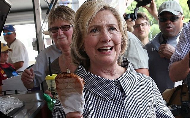 Democratic presidential hopeful and former Secretary of State Hillary Clinton holds a pork chop on a stick as she tours the Iowa State Fair on August 15, 2015 in Des Moines, Iowa.  (Justin Sullivan/Getty Images/AFP)