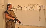 Timothy Paul Jacobs-Woodworth in Syria, with his Hebrew-language graffiti (Facebook)