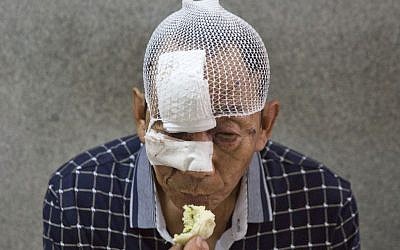 A man with his wounds bandaged eats a bun in a hospital receiving victims of an explosion in northeastern China's Tianjin municipality, Thursday, Aug. 13, 2015. (AP Photo/Ng Han Guan)