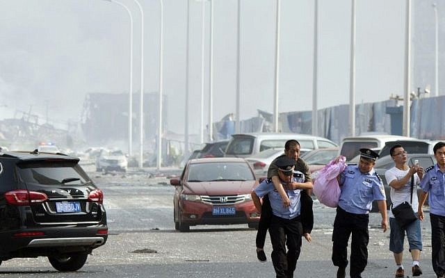 Chinese police help a man to safety near the site of an explosion in northeastern China's Tianjin municipality, Thursday, Aug. 13, 2015. (AP Photo/Ng Han Guan) Chinese police help a man to safety near the site of an explosion in northeastern China's Tianjin municipality, Thursday, Aug. 13, 2015. (AP Photo/Ng Han Guan)