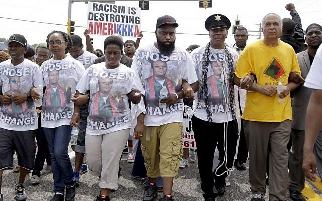 Michael Brown Sr., center, takes part in a march in remembrance of his son, Michael Brown, Sunday, Aug. 9, 2015, in Ferguson, Mo. (AP Photo/Jeff Roberson) Michael Brown Sr., center, takes part in a march in remembrance of his son, Michael Brown, Sunday, Aug. 9, 2015, in Ferguson, Mo. (AP Photo/Jeff Roberson)