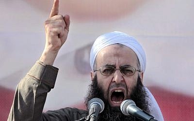 FILE - In this March 4, 2011, file photo, Sheikh Ahmad al-Assir, a Lebanese anti-Syrian regime leader, addresses his supporters during a demonstration against Syrian President Bashar Assad at the Martyrs square in Beirut, Lebanon. (AP Photo/Hussein Malla,File)