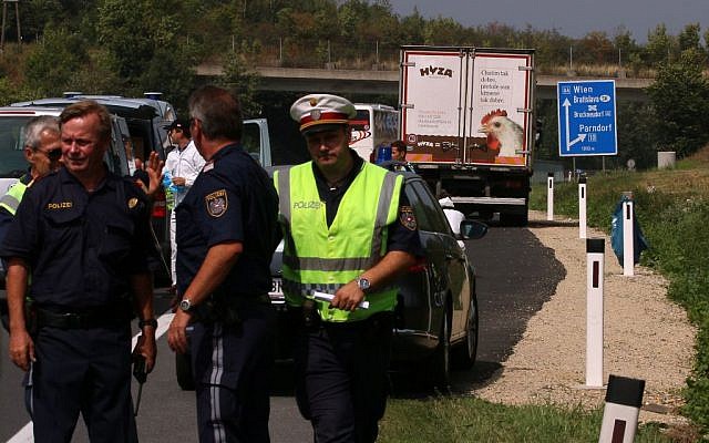 Police stand in fron of a truck parked on the shoulder of the highway A4 near Parndorf south of Vienna, Austria, Thursday, Aug 27, 2015. At least 20 migrants were found dead in the truck parked on the Austrian highway leading from the Hungarian border, police said. (AP Photo/Ronald Zak) Police stand in fron of a truck parked on the shoulder of the highway A4 near Parndorf south of Vienna, Austria, Thursday, Aug 27, 2015. At least 20 migrants were found dead in the truck parked on the Austrian highway leading from the Hungarian border, police said. (AP Photo/Ronald Zak)