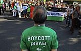 Protesters shout slogans during a rally in Paris, France, June 3, 2010, as they demonstrate against Israel's raid on a Gaza-bound aid ship; a man in the foreground wears a T-shirt calling for a boycott on Israel. (Jacques Brinon/ AP /File)