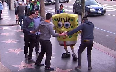 Jewish Yeshivah students unknowingly participate in a social experiment to help costumed actor who collapsed on Hollywood Boulevard on the Jimmy Kimmel show, August 25, 2015. (YouTube)