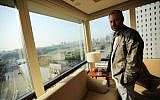 In this Tuesday, April 1, 2014, file photo, Noel Biderman, chief executive of Avid Life Media Inc., which operates AshleyMadison.com., poses by a hotel room window overlooking the Imperial Palace grounds during a photo session in Tokyo. (AP/Eugene Hoshiko, File)