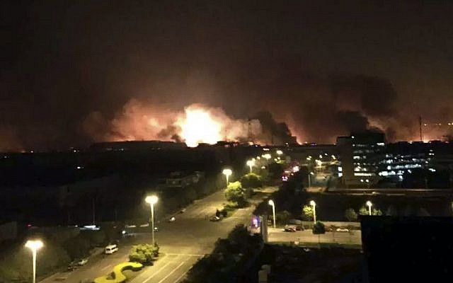 Smoke and fire erupt into the night sky after an explosion in the Binhai New Area in north China's Tianjin Municipality on Thursday Aug. 13, 2015. (Yue Yuewei/Xinhua via AP)