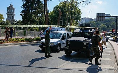 Police officer secure the road that leads to Istanbul's Dolmabache Palace, Wednesday, Aug 19, 2015 following an armed attack. Turkish police arrested two people after shots were fired at officers guarding the Ottoman-era palace that is a major tourist attraction, Turkey's state-run news agency said. (Emrah Gurel/AP)