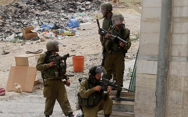 Illustrative photo of IDF soldiers during a protest at the Qalandiya checkpoint near the West Bank city of Ramallah on June 5, 2014. (Issam Rimawi/Flash90) Illustrative photo of IDF soldiers during a protest at the Qalandiya checkpoint near the West Bank city of Ramallah on June 5, 2014. (Issam Rimawi/Flash90)