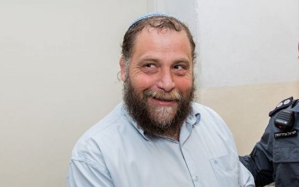 Lehava chairman Bentzi Gopstein is brought to the Jerusalem Magistrate's Court on December 16, 2014. (Yonatan Sindel/Flash90)