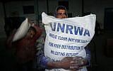 Palestinians receive their monthly food aid at a United Nations distribution center in the Rafah refugee camp, in southern Gaza Strip, February 8, 2015 (Abed Rahim Khatib/Flash90)