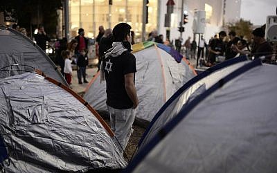 Israeli social activists protesting high housing costs near tents on Rothschild Boulevard in Tel Aviv on March 1, 2015. (Tomer Neuberg/Flash90)