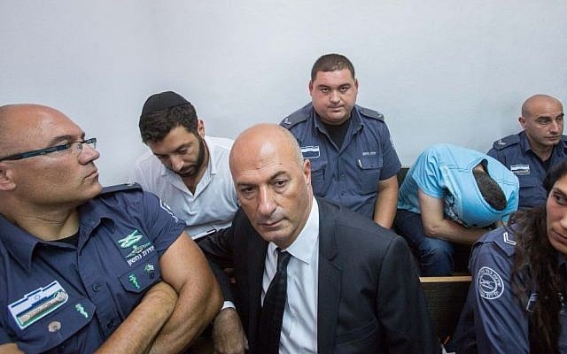 Gery Shalon, second left, and Ziv Orenstein, second right, suspected of being involved in several fraud schemes tied to the NYSE, seen in the Jerusalem Magistrates' Court, July 22, 2015. (Yonatan Sindel/Flash90) Gery Shalon, second left, and Ziv Orenstein, second right, suspected of being involved in several fraud schemes tied to the NYSE, seen in the Jerusalem Magistrates' Court, July 22, 2015. (Yonatan Sindel/Flash90)