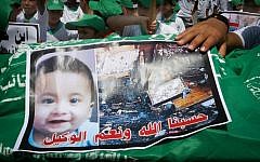 Palestinian children carry a funeral stretcher with a picture of 18-month-old Ali Saad Dawabsha, the toddler who was burned to death by suspected Jewish extremists, on August 1, 2015 in Khan Yunis, southern Gaza Strip, during a demonstration simulating a funeral ceremony and organized by Palestinian Islamist Hamas supporters in reaction to the death of the baby. (Abed Rahim Khatib/Flash 90)