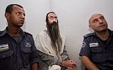 Yishai Schlissel, center, an ultra-Orthodox Jew who stabbed a teenage girl to death at the Jerusalem Gay Pride Parade, is seen at the Jerusalem Magistrates Court on August 5, 2015. (Yonatan Sindel/Flash90)