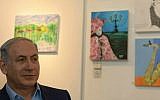 Prime Minister Benjamin Netanyahu visits an exhibition of paintings by the late Hadar Goldin, killed in battle in Gaza with his body never recovered, at the artists' village Ein Hod in northern Israel, on August 10, 2015. (Amos Ben Gershom/GPO)
