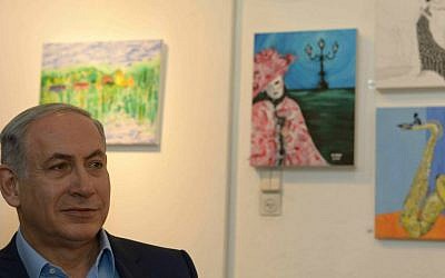 Prime Minister Benjamin Netanyahu visits an exhibition of paintings by the late Hadar Goldin, killed in battle in Gaza with his body never recovered, at the artists' village Ein Hod in northern Israel, on August 10, 2015. (Amos Ben Gershom/GPO)