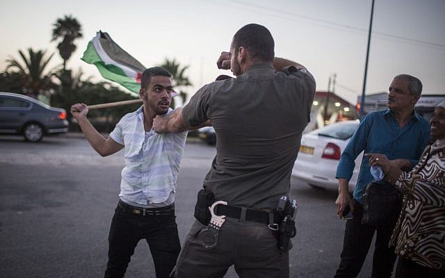 Palestinians protesters clash with Israeli police during a demonstration in Ashkelon on August 16, 2015. (Hadas Parush/Flash90) Palestinians protesters clash with Israeli police during a demonstration in Ashkelon on August 16, 2015. (Hadas Parush/Flash90)