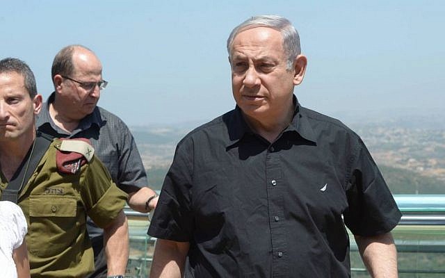 Israeli Prime Minister Benjamin Netanyahu seen during his visit to the northern border of Israel on August 18, 2015. Defense Minister Yaalon is behind him. (Amos Ben Gershom/GPO) Israeli Prime Minister Benjamin Netanyahu seen during his visit to the northern border of Israel on August 18, 2015. Defense Minister Yaalon is behind him. (Amos Ben Gershom/GPO)