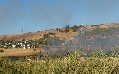 A large fire raging near Kfar Sold, caused by missiles fired from the Syrian side of the Israeli-Syrian border and hitting open areas in the Golan Heights in northern Israel on August 20, 2015. (Basel Awidat/Flash90)
