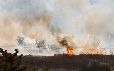 A large fire raging near Kfar Sold, caused by missiles fired from the Syrian side of the Israeli-Syrian border and hitting open areas in the Golan Heights in northern Israel on August 20, 2015. (Photo by Basel Awidat/Flash90)